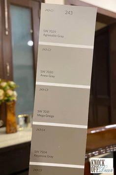 the interior paint colors are gray, white, and brown in this kitchen cabinetry