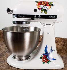 a white mixer sitting on top of a counter