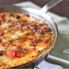 a close up of a pizza in a pan on a table