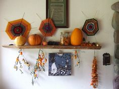 there are many decorations on the shelf above the bed and below them is an orange pumpkin