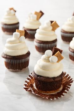 chocolate cupcakes with white frosting and marshmallows on the top