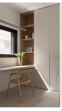 an empty room with a desk and bookshelf next to a large open window