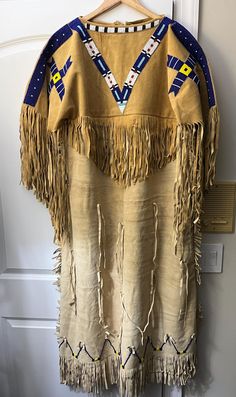 Native American Lakota women buckskin dress in size XL and hand beaded moccasins in size 9,5.  The dress has beaded native accents on the front of the cape and fringes on the side. It is 52 inches long.   The moccasins have a leather sole made of harder leather making them very durable for wearing daily and dancing. Moccasins measure about 11" from toe to heal and 3 3/4" across the ball of foot. Buckskin Dress, Beaded Moccasins, Leather Making, Fantasy Clothes, Indian Inspired, American Clothing, Fantasy Clothing, American Women, Hand Beading