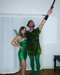 a man and woman dressed up as tinkerbells