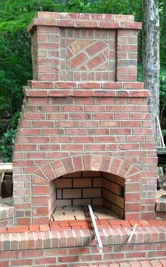 an outdoor brick oven in the woods