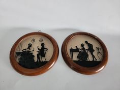 two earrings with silhouettes of people playing instruments