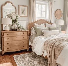 a bed sitting in a bedroom next to a dresser and window with flowers on it