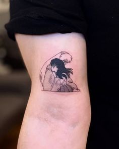 a woman's arm with a tattoo on it that has an image of two people hugging