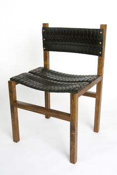 a wooden chair with black leather upholstered on it's back and seat