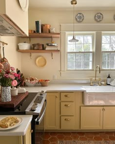 a kitchen filled with lots of counter space next to a sink and stove top oven