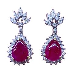 An exquisite design for this refined and chic earrings in 18k gold, with two pieces of Burma rubies, cabochon cut, fine quality, very stunning color , of 6.50 carats, and special cut diamonds of 2.11 carats, F/VS, top quality. Handcrafted by artisan goldsmith. Excellent manufacture and quality. Complete with AIG report. Note: on my shipment, customers from all countries, not pay taxes and duty. Luxury Diamond Earrings With Prong Setting, Luxury Ruby Earrings With Prong Setting, Ruby Gemstone Diamond Earrings For Formal Occasions, Formal Ruby Gemstone Diamond Earrings, Exquisite White Gold Ruby Earrings, Exquisite Ruby Earrings In White Gold, Elegant Ruby Diamond Earrings, Luxury Oval Ruby Earrings, Luxury Ruby Gemstone Earrings