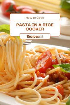 pasta in a rice cooker recipe on a white plate with basil leaves and tomatoes