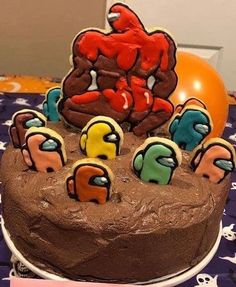 a chocolate cake with icing and decorations on it sitting on top of a table