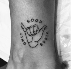 a black and white photo of a person's foot with a tattoo on it