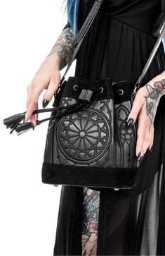 Embrace your inner goth with our goth black sanctum bucket bag. crafted with meticulous attention to detail, this bag seamlessly combines dark aesthetics with practicality. perfect for carrying your essentials, it exudes an aura of mystery and elegance that will make heads turn wherever you go Luxury Bucket Bag With Metal Details, Cheap Punk Halloween Bags, Luxury Travel Bucket Bag With Leather Lining, Punk Style Halloween Bags, Cheap Black Alternative Style Bags, Cheap Alternative Black Bags, Cheap Gothic Bags For Halloween, Affordable Gothic Halloween Bags, Window Embroidery