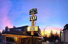 the crystal bay club is lit up at night with lights on it's sign