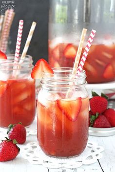 two mason jars with strawberries in them