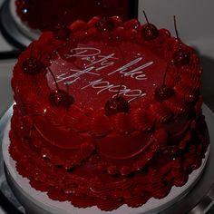 a close up of a red cake on a table