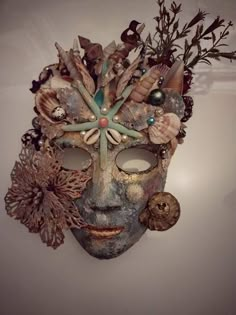 a mask with shells and seashells on it