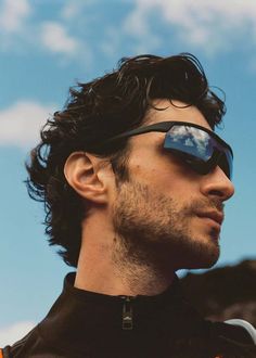 a man with sunglasses on his face looking off into the distance