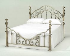 an image of a metal bed frame with white sheets and pillows on the front page