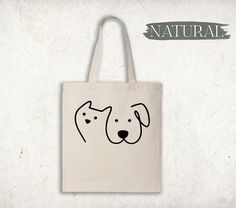 a tote bag with a dog's face drawn on the front and side