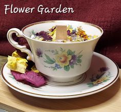 a tea cup with flowers in it on a saucer