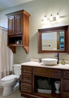 a bathroom with a toilet, sink and mirror in it's centerpieces