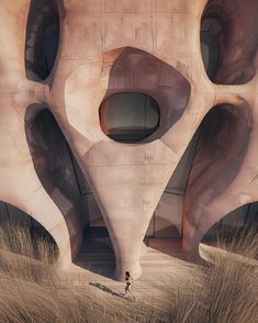 a person walking in front of an unusual building