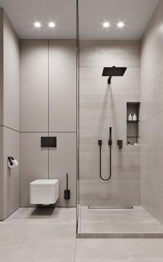 a bathroom with a walk in shower next to a white toilet and wall mounted urinal