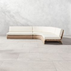 a white couch sitting on top of a stone floor