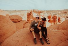 two people sitting on rocks in the desert