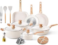 an assortment of kitchen utensils and cooking implements are arranged on a white surface