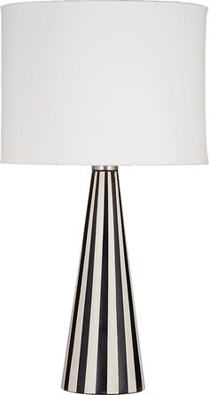 a black and white striped lamp with a white shade on the bottom, in front of a white background