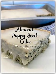 a close up of a cake on a plate with the words almond poppy seed cake