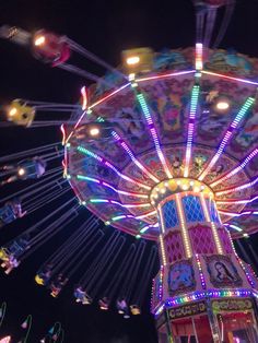 a carnival ride at night with colorful lights