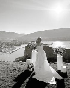 a woman in a wedding dress standing next to some flowers