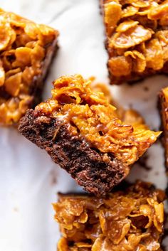 some brownies are stacked on top of each other with chocolate and oatmeal toppings