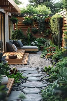 a small garden with lots of plants and rocks