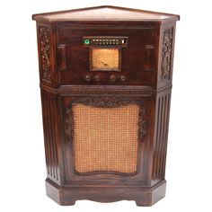 an old fashioned radio sitting on top of a wooden stand