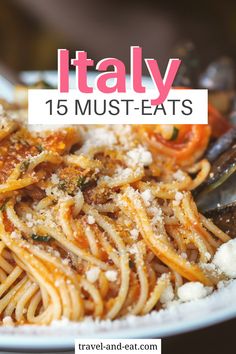 a white plate topped with pasta covered in parmesan cheese and tomato sauce next to a fork