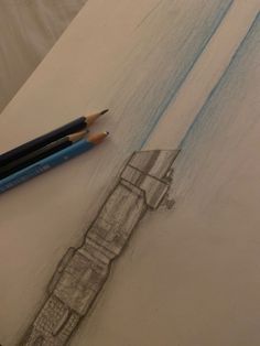 a pencil drawing of a building and two blue crayons