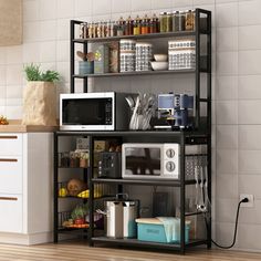 a microwave oven sitting on top of a black shelf next to a white kitchen counter