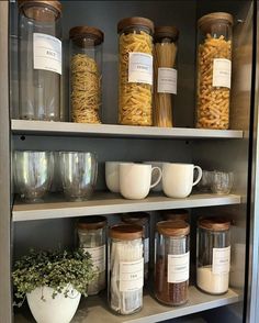 the shelves are filled with many different types of food and drink in glass jars on them