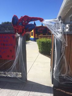 the entrance to a spider - man themed birthday party is decorated with plastic sheeting