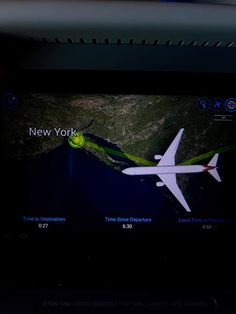 an airplane is flying in the sky at night with new york written on it's screen