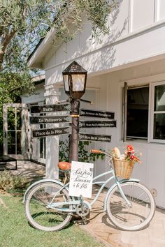 a bicycle parked next to a street light with signs on the front and back of it