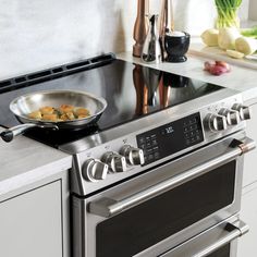 a stove top oven sitting inside of a kitchen next to a counter with an appliance on it