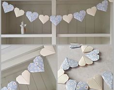 paper hearts are hanging on the wall and in front of some bookshelf shelves