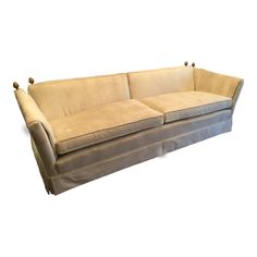 a beige couch sitting on top of a white floor